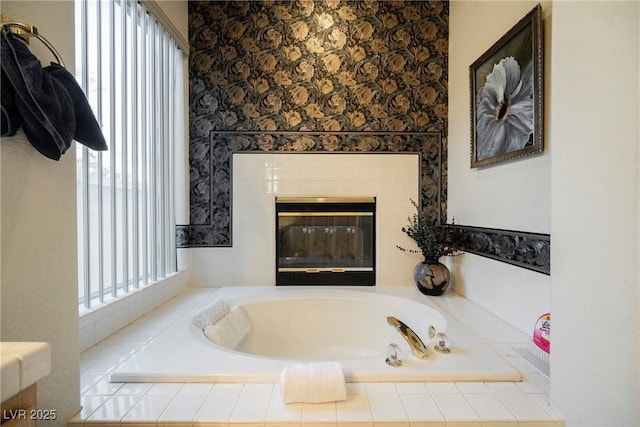 bathroom featuring tiled tub and a fireplace