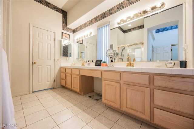 bathroom featuring vanity, a shower with door, and tile patterned flooring