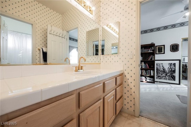 bathroom with ceiling fan, vanity, and tile patterned flooring