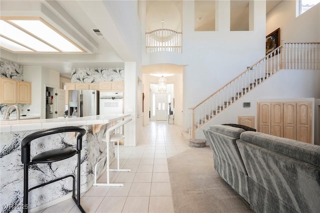 interior space featuring an inviting chandelier, sink, and a high ceiling