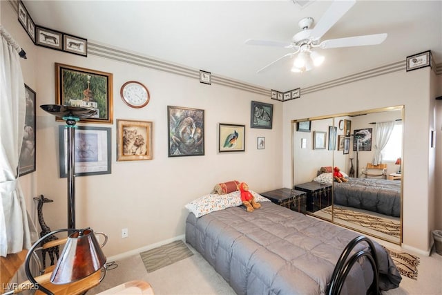 carpeted bedroom featuring ceiling fan, ornamental molding, and a closet