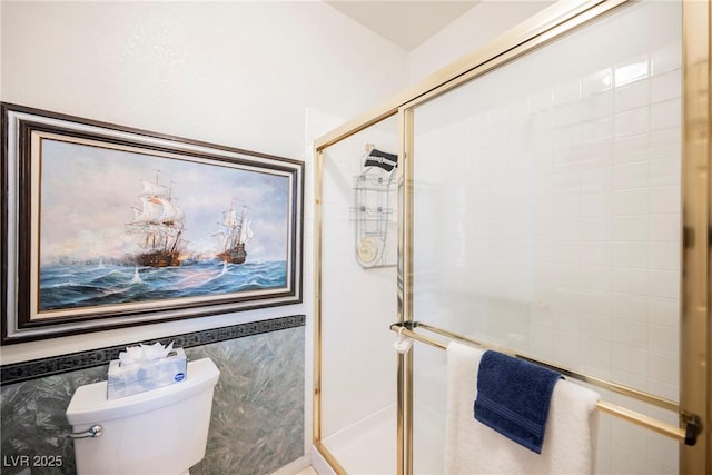 bathroom featuring tile walls, an enclosed shower, and toilet