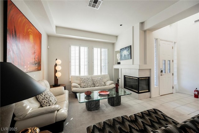 living room with light carpet and a fireplace