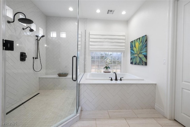 bathroom with shower with separate bathtub