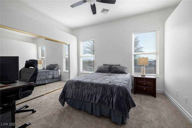 carpeted bedroom with ceiling fan and a closet