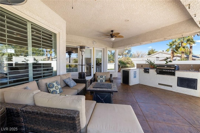 view of patio / terrace featuring outdoor lounge area, area for grilling, sink, and ceiling fan