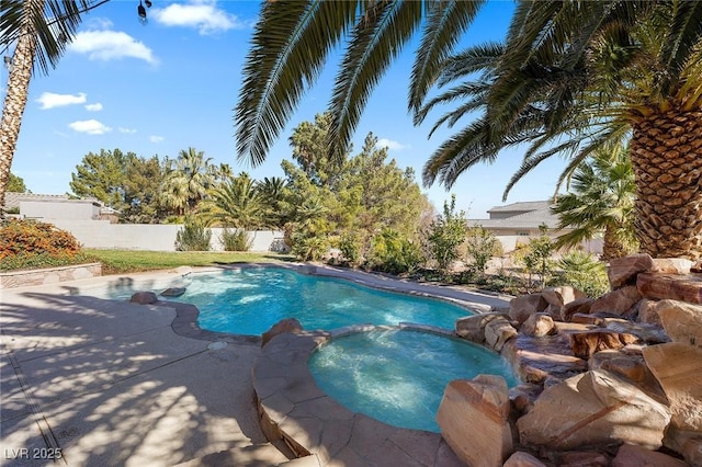 view of swimming pool featuring an in ground hot tub