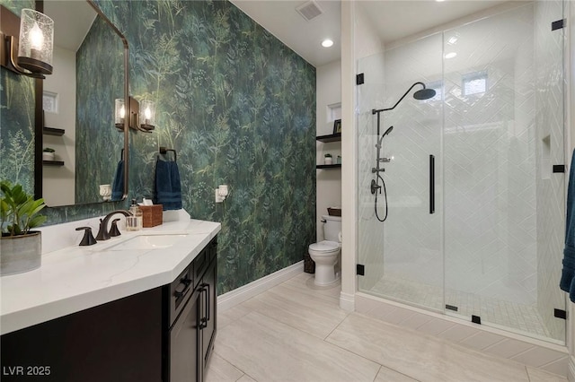 bathroom featuring vanity, an enclosed shower, and toilet