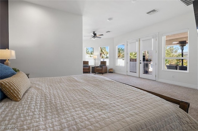 bedroom featuring multiple windows, access to exterior, light carpet, and french doors