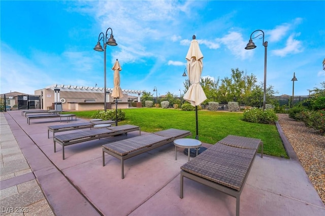 view of home's community featuring a yard, a pergola, and a patio