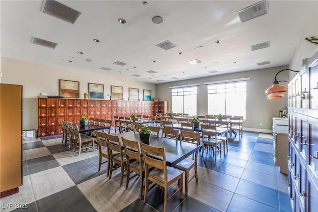 dining room featuring dark tile patterned flooring