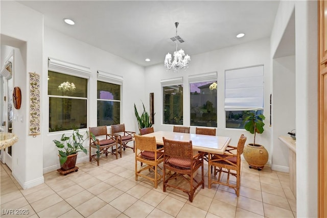 dining area featuring an inviting chandelier and light tile patterned floors