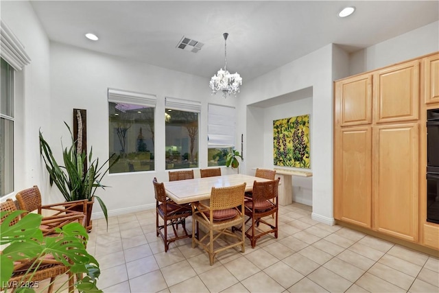 dining area with an inviting chandelier and light tile patterned floors