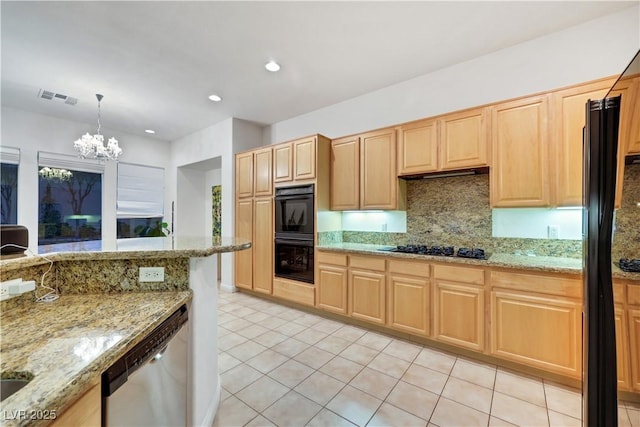 kitchen featuring hanging light fixtures, decorative backsplash, light stone counters, and black appliances