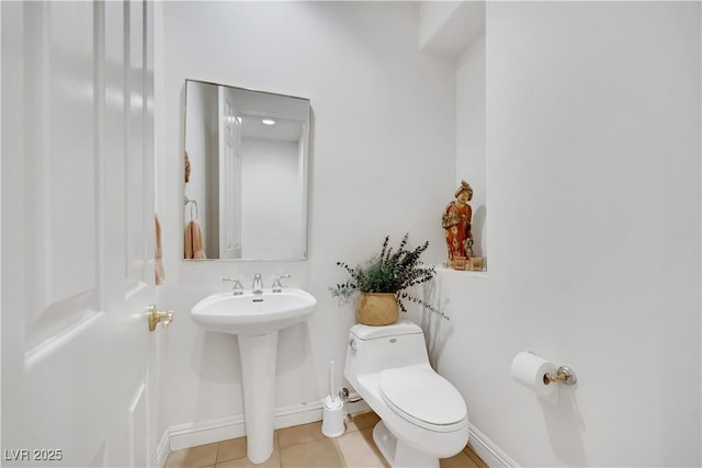 bathroom with tile patterned flooring, sink, and toilet