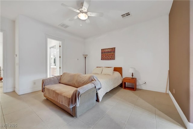 bedroom with connected bathroom, light tile patterned floors, and ceiling fan