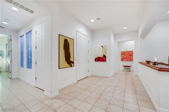 foyer entrance with light tile patterned floors