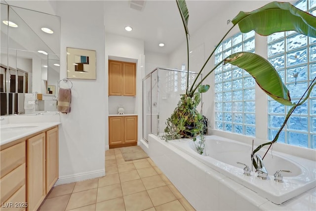 bathroom featuring independent shower and bath, vanity, and tile patterned floors