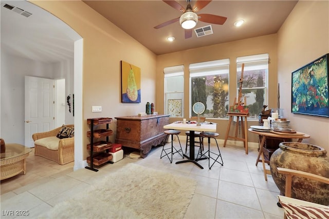 interior space with light tile patterned floors and ceiling fan