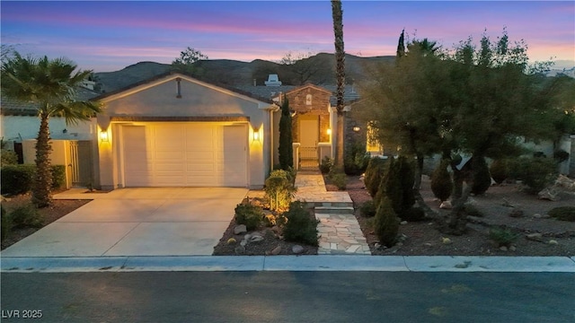 view of front of house with a mountain view and a garage