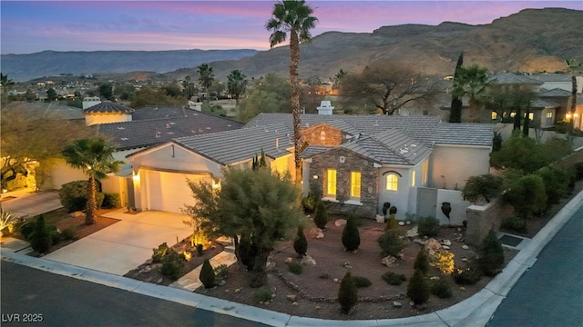 view of front of home featuring a mountain view and a garage