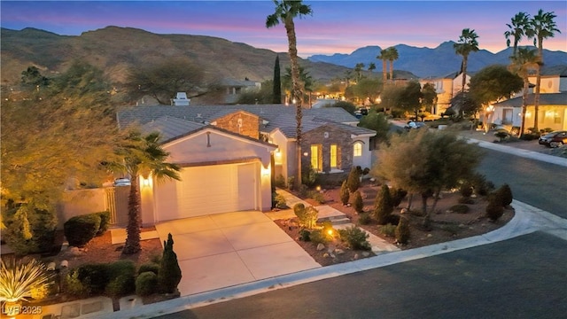 view of front of home featuring a mountain view and a garage