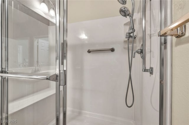 bathroom featuring a shower with shower door