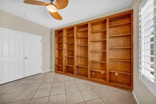 unfurnished bedroom featuring ceiling fan and light tile patterned flooring