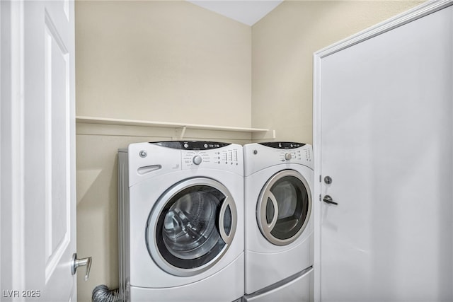 laundry area featuring separate washer and dryer and laundry area