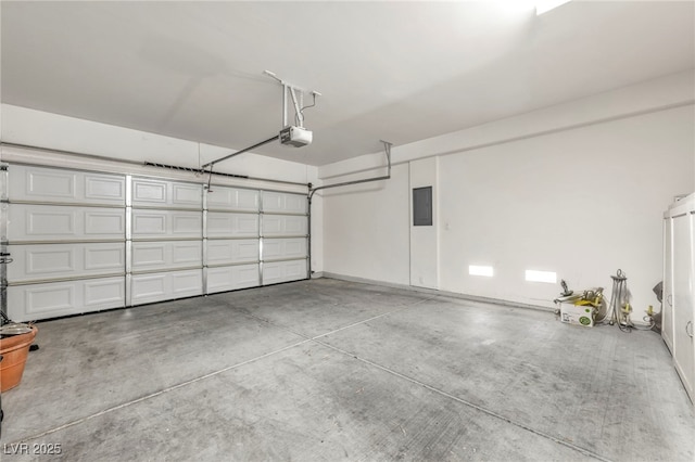 garage with a garage door opener and electric panel