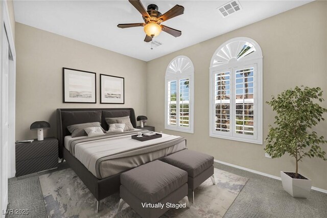 bedroom featuring baseboards, visible vents, multiple windows, and carpet