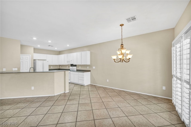 kitchen featuring white cabinetry, white appliances, light tile patterned floors, a chandelier, and pendant lighting