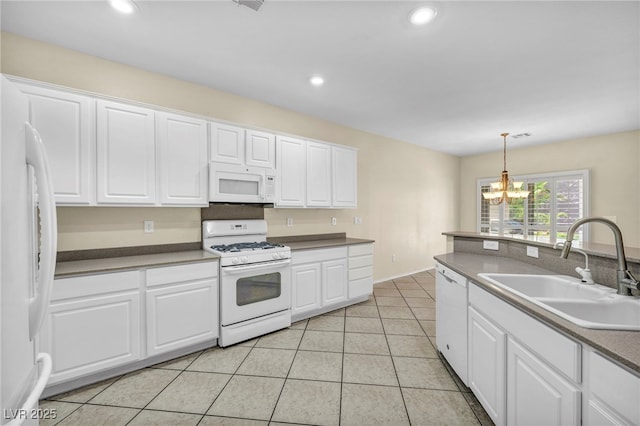 kitchen featuring a sink, white cabinets, a chandelier, and white appliances