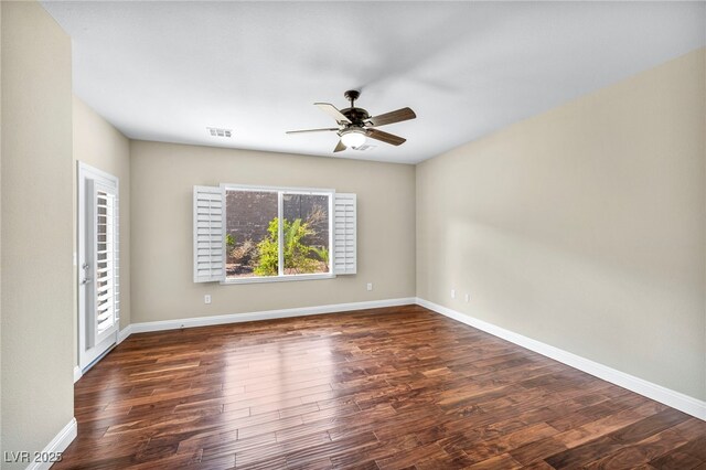 spare room featuring wood finished floors, visible vents, ceiling fan, and baseboards
