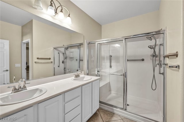 bathroom featuring tile patterned floors, an enclosed shower, and vanity