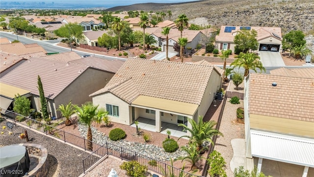 birds eye view of property with a mountain view and a residential view