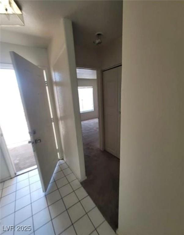 corridor featuring light tile patterned floors