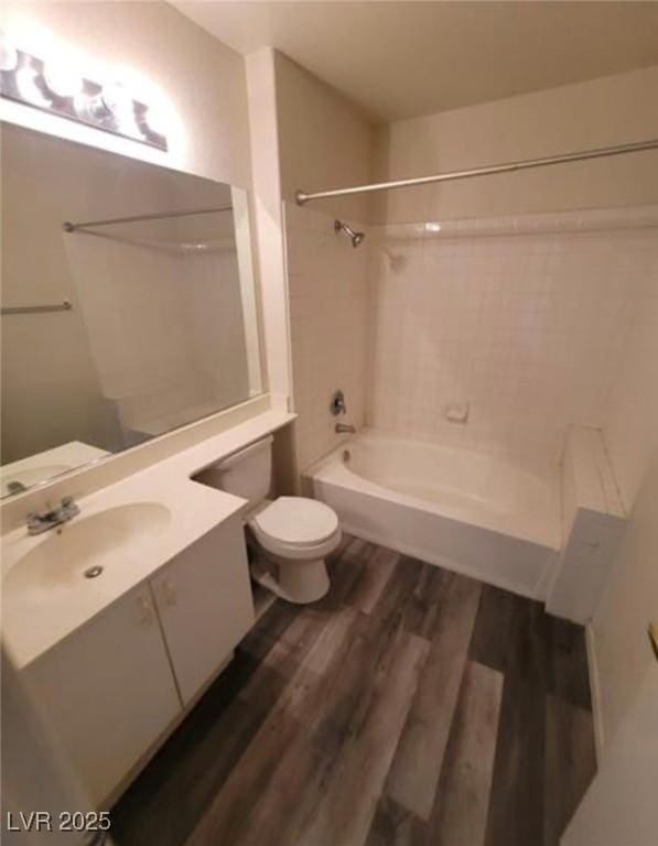 full bathroom featuring vanity, hardwood / wood-style flooring, shower / bathtub combination, and toilet