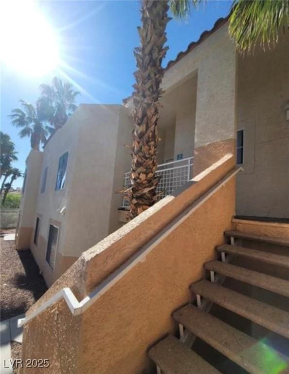 view of side of property with a balcony