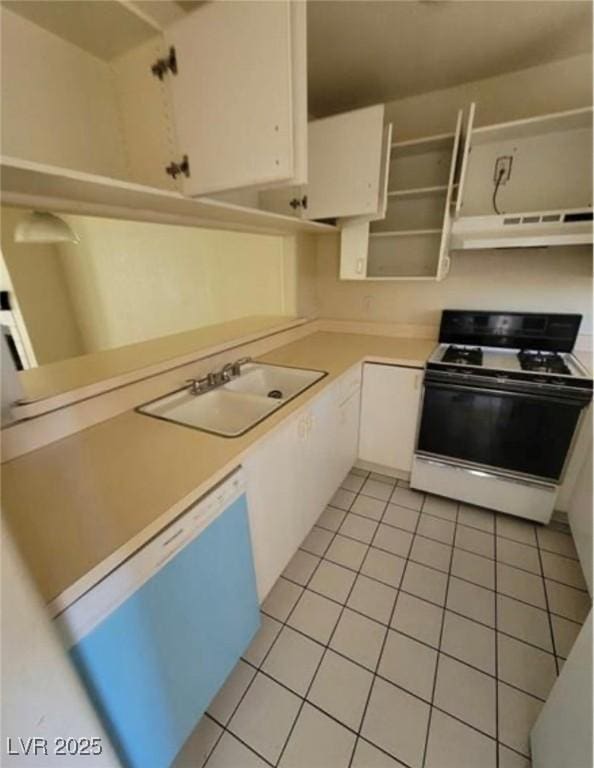 kitchen with white cabinetry, white range oven, sink, and light tile patterned flooring