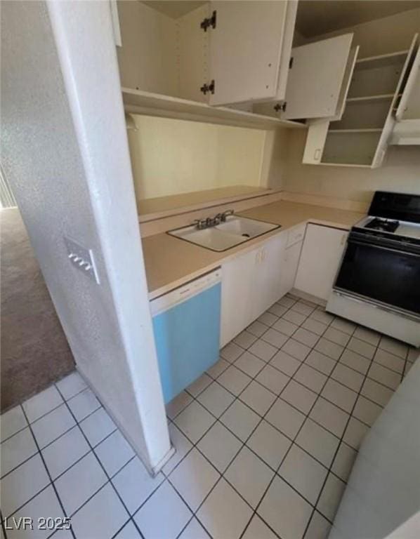 kitchen with light tile patterned floors, sink, white cabinetry, white dishwasher, and range with electric stovetop