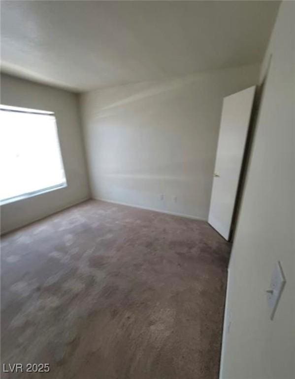 empty room featuring dark carpet