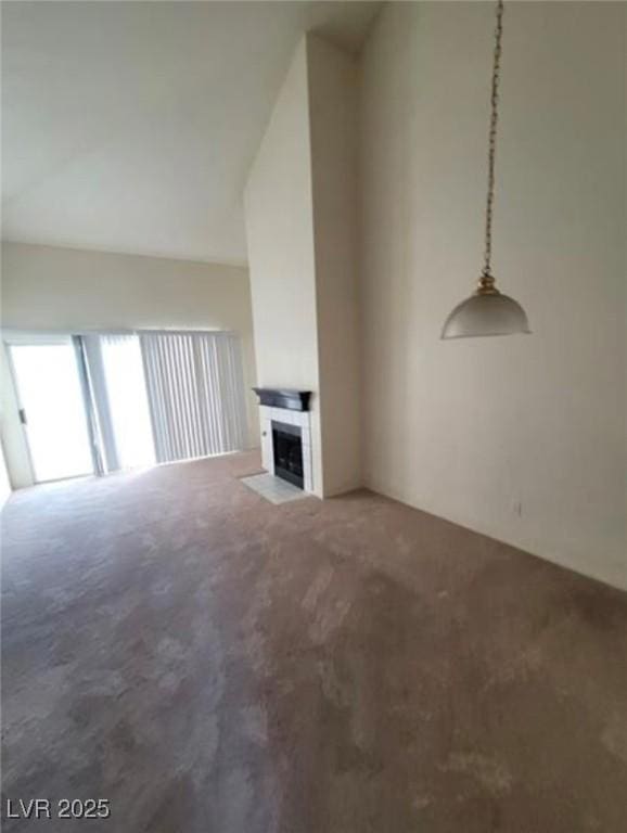 unfurnished living room with a fireplace, carpet flooring, and high vaulted ceiling