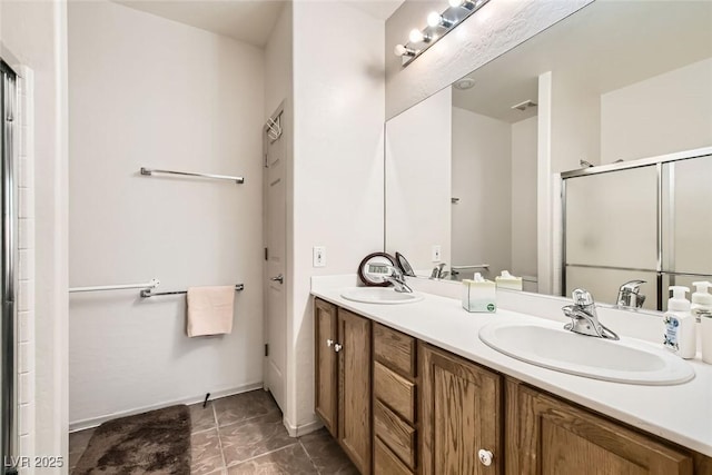 bathroom with vanity and a shower with shower door