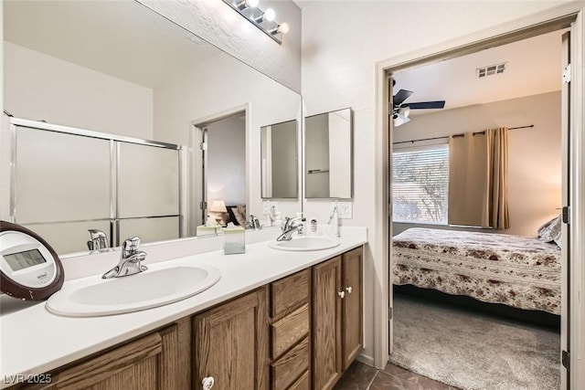 bathroom featuring vanity, a shower with door, and ceiling fan