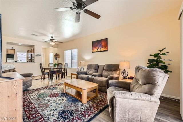 living room featuring hardwood / wood-style flooring and ceiling fan