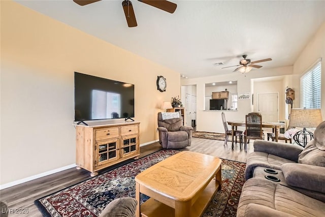 living room with hardwood / wood-style floors and ceiling fan