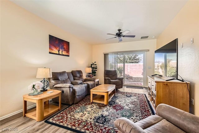 living room featuring ceiling fan and light wood-type flooring