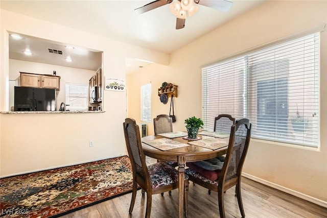 dining space featuring ceiling fan, a healthy amount of sunlight, and light hardwood / wood-style floors