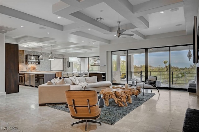 tiled living room with coffered ceiling, beam ceiling, and ceiling fan